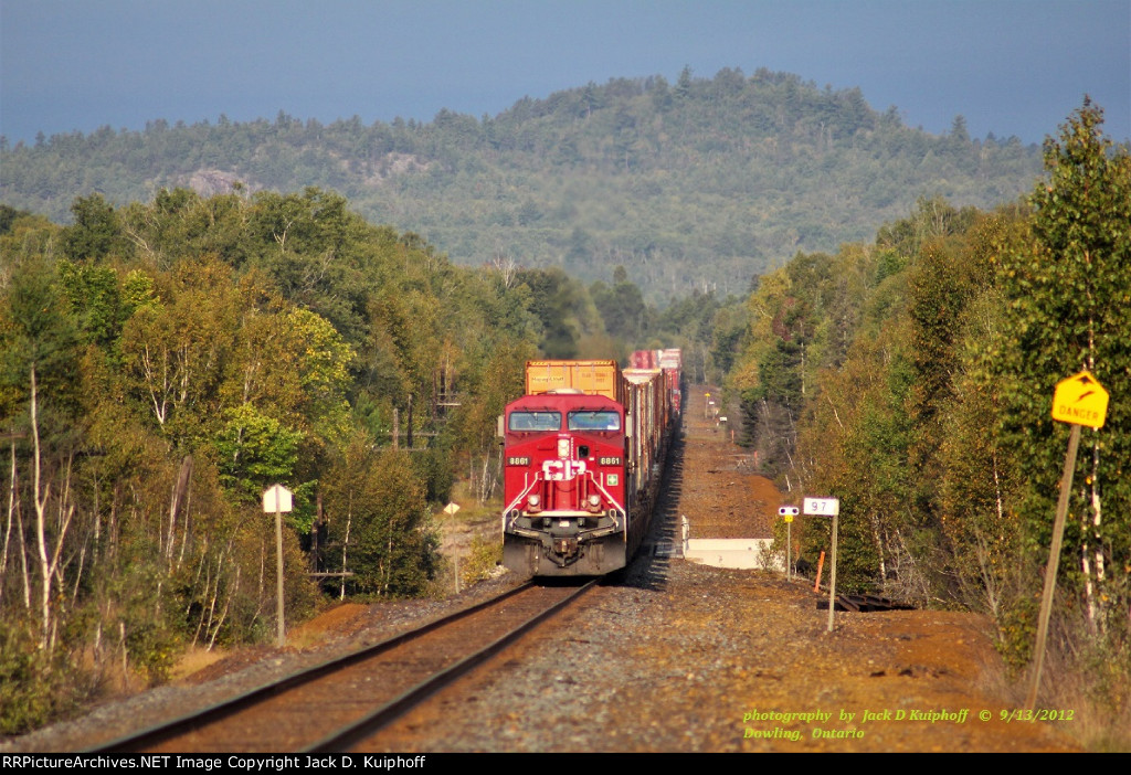 Dropping down into the bowl, and now a flat shot to Sudbury, we catch CP, Canadian Pacific 8861, leading an eastbound at mp97 on the Cartier sub at  Dowling, Ontario, September 13, 2012.  